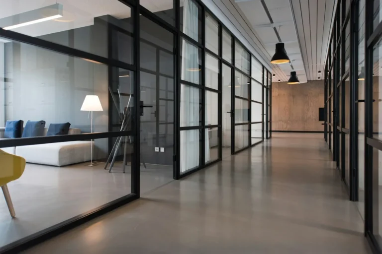 Bright professional office hallway with glass partitions